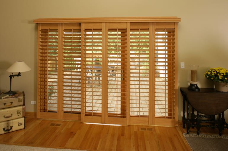 Faux wood shutters on sliding door going to full porch.